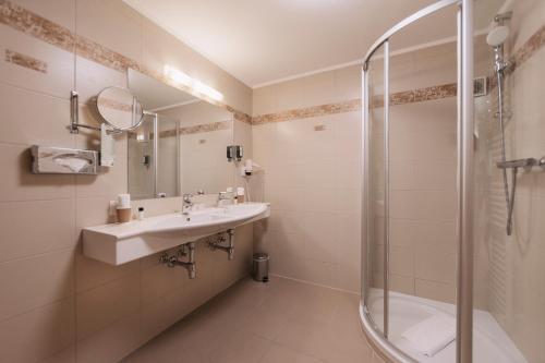 a bathroom with a sink and a shower at Wellness Aparthotel Panorama Alpin - Ferienwohnungen Jerzens im Pitztal in Jerzens