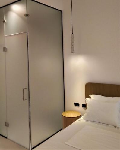 a bedroom with a sliding glass door next to a bed at Abonora Drymades in Dhërmi