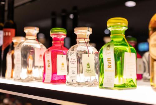 a row of bottles of alcohol on a shelf at Hotel Weißes Ross in Kulmbach