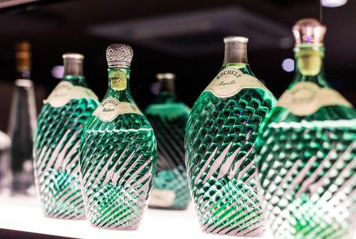 a group of green glass bottles sitting on a table at Hotel Weißes Ross in Kulmbach