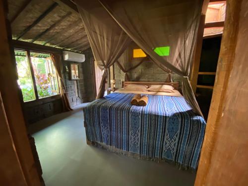 a bedroom with a bed in a tent at Balian Beach Villa in Selemadeg
