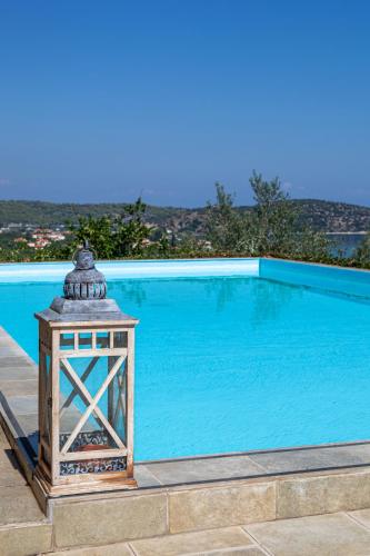 a lantern next to a swimming pool at Epidavros Land villa Artemis in Ancient Epidauros