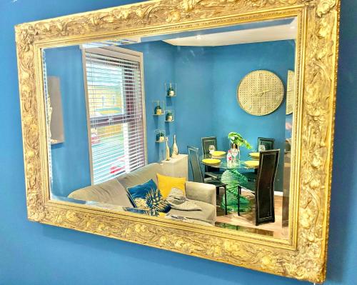 a mirror reflecting a living room with a couch at Cozy Two Bedroom - A Stroll from Gardens to Beach - With Parking in Bournemouth