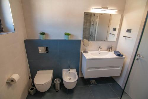 a bathroom with a toilet and a sink at Luxury apartment Grotta with sea view and swimming pool in Premantura