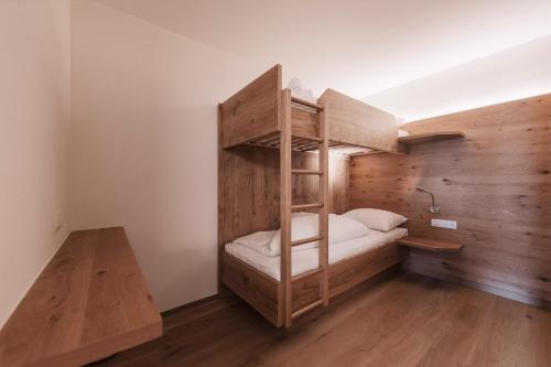 a bedroom with a bunk bed with a ladder at Wellness Aparthotel Panorama Alpin - Ferienwohnungen Jerzens im Pitztal in Jerzens