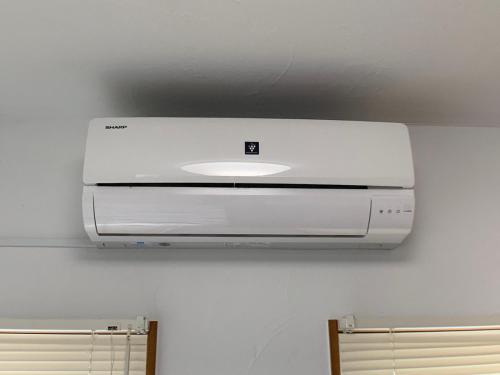 a white printer is hanging on a wall at Nagayama Home in Asahikawa