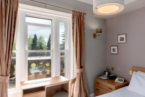 Cama o camas de una habitación en Windermere Manor Hotel