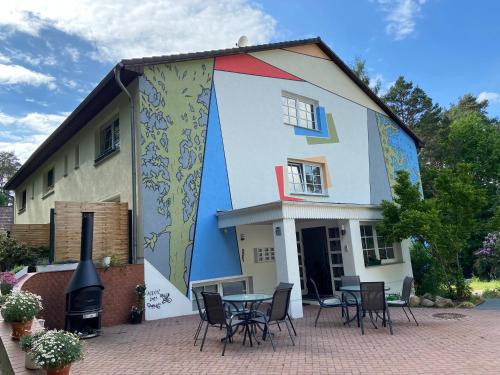 a house with a painting on the side of it at Waldwerk Wurlgrund Lychen in Lychen