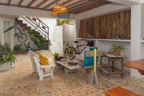 a living room with a table and chairs and a bike at Quatro palos in Rincón