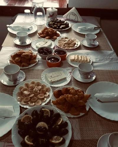 a table with many plates of food on it at Castle Hotel in Gjirokastër