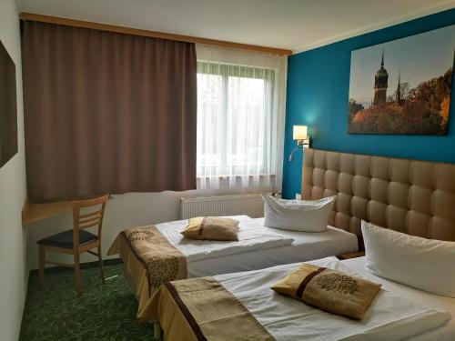 Postel nebo postele na pokoji v ubytování ACRON Hotel Wittenberg