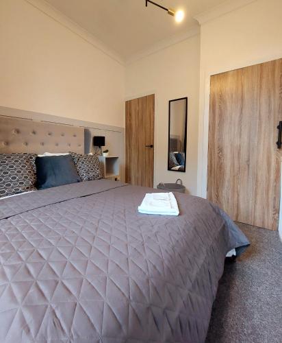 una camera da letto con un grande letto e un piumone viola di Modern & Bright, G/F, 1BR APT. Real Hidden Gem a Hamilton