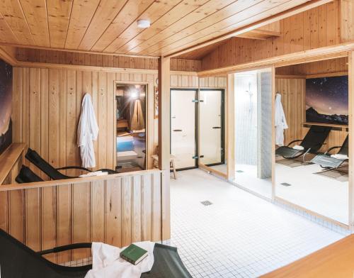 a room with wood paneled walls and a large glass door at Heimspitze - Alpenhotel & Wirtshaus in Gargellen