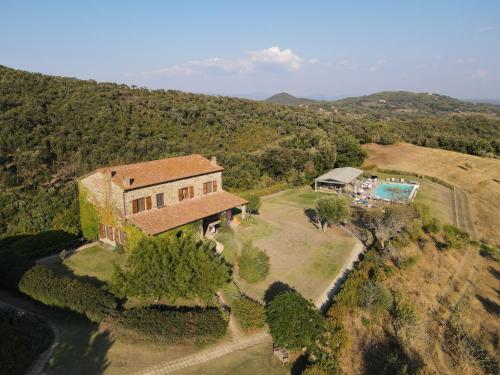 an aerial view of a house on a hill at Agriturismo Boschi di Montecalvi in Suvereto