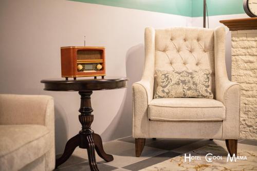 a chair and a table with a radio on it at Hotel COOL MAMA in Brinchang