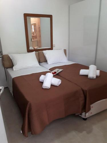 a bedroom with a large bed with towels on it at Cozy Studio in Athens