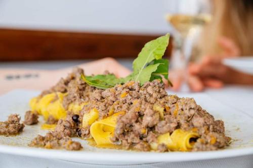 a plate of food with meat and cheese on it at Acquarello in Lapedona