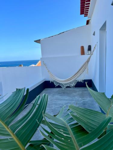 a room with a hammock and a plant at Casa Família Açoriana in Vila Franca do Campo