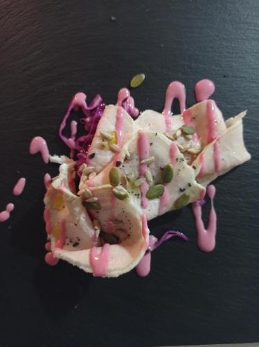 a piece of food covered in pink sauce and seeds at Acquarello in Lapedona