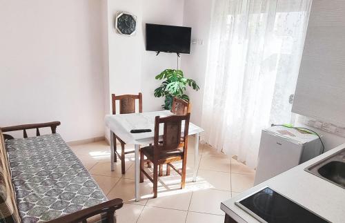 a kitchen and dining room with a table and chairs at Hamit Hoxha - Pogradec Near Ohrid Lake in Buçimas