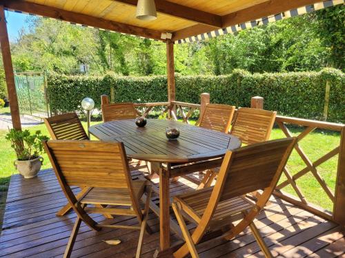 a wooden table and chairs on a wooden deck at Antonella's Home in Cavallino-Treporti
