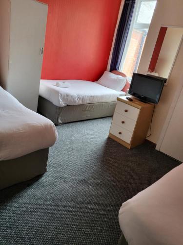Ένα ή περισσότερα κρεβάτια σε δωμάτιο στο Tulip Hotel Blackpool