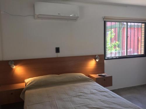 a bedroom with a large bed and a window at Apart Picaflores in Merlo