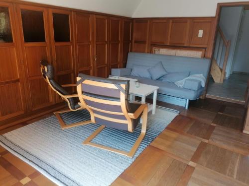 ティメンドルファー・シュトラントにあるFerienwohnung-Stoermannのリビングルーム(ソファ、椅子、テーブル付)