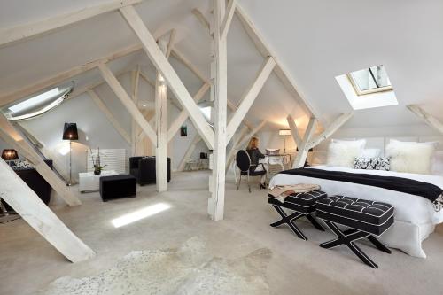 a bedroom with a large bed in a attic at Clarance Hotel Lille in Lille