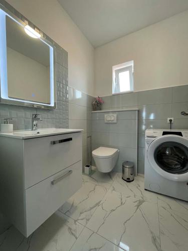 a bathroom with a washing machine and a washer at House Stojakovic in Banjol