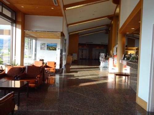 a lobby with chairs and tables in a building at Grand Park Hotel Okubiwako Makino in Takashima