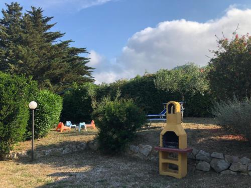 a playground with a play equipment in a yard at Appartamenti Sterlizia 2 in Lacona