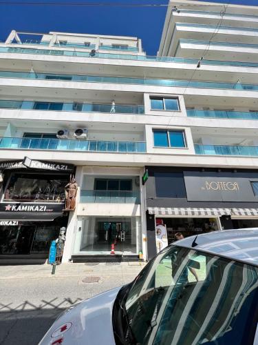 a building on a street with a car parked in front at Aphrodite Plaza in Larnaca