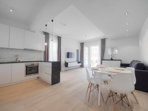 a kitchen and living room with a table and chairs at Horizon-Two Bedroom Apartment Partial Sea View Charlene in Becici