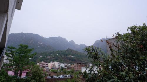 a view of a city with mountains in the background at Saatvik Homestay in Katra