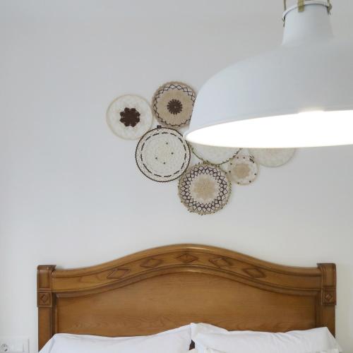 a bedroom with a bed and a heart wall art at Piso Virgen del mar in Laxe