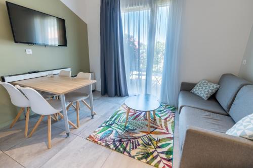 a living room with a couch and a table at Kyriad Résidence Cabriès - Plan de Campagne in Cabriès