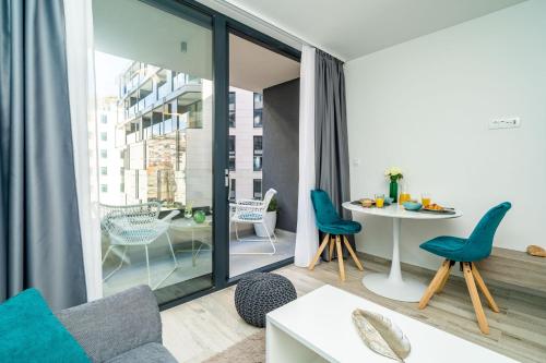 a living room with blue chairs and a table at Downtown MaritA207 in Dubrovnik