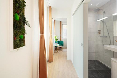 a bathroom with a walk in shower and a sink at EH Apartments Merkur in St. Gallen