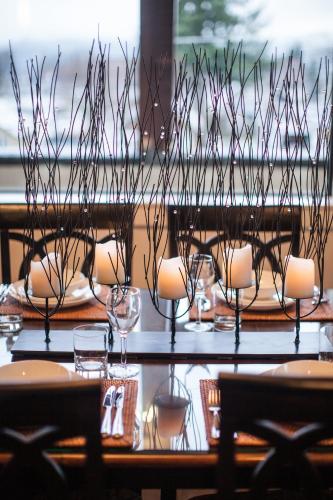 a table with chairs and wine glasses on it at Alpenglow Penthouse by Revelstoke Vacations in Revelstoke