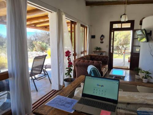a living room with a laptop on a wooden table at CASA CAFAYATE LA SOÑADA in Cafayate
