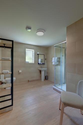 a bathroom with a glass shower and a sink at St Mellion Estate in St. Mellion