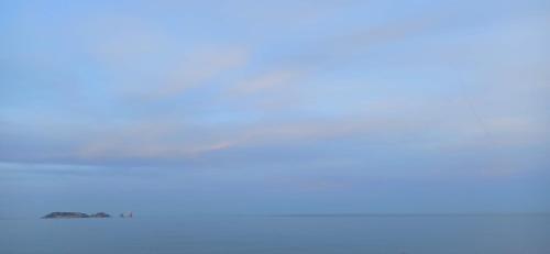 an airplane flying in the sky over the ocean at Can Costals Olivo in Pals