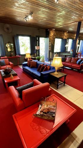 a large living room with couches and tables at Hotel Fazenda Vilarejo All Inclusive in Conservatória