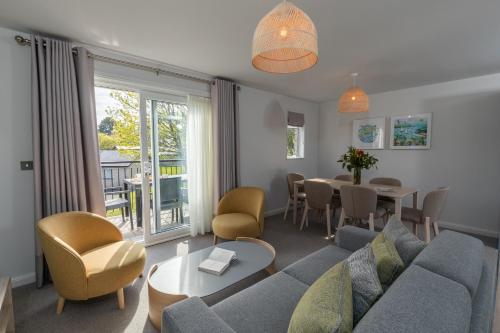 a living room with a couch and a table at St Mellion Estate in St. Mellion