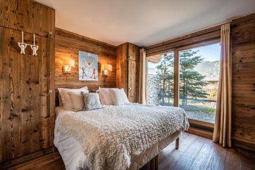 Postel nebo postele na pokoji v ubytování Apartment Moabi Le Praz Courchevel - by EMERALD STAY