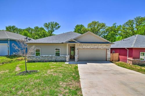 a house with a driveway and a garage at Newly Constructed Mansfield Home with Fenced Yard! in Mansfield