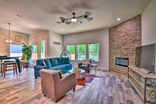 a living room with a blue couch and a fireplace at Newly Constructed Mansfield Home with Fenced Yard! in Mansfield