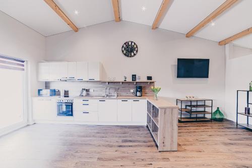 a kitchen with white cabinets and a table in a room at Große Ferienwohnung mit Balkon und perfekter Lage in Eggenthal