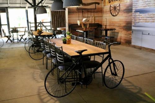 a bike parked in a room with tables and chairs at Hotel Fazenda Vilarejo All Inclusive in Conservatória